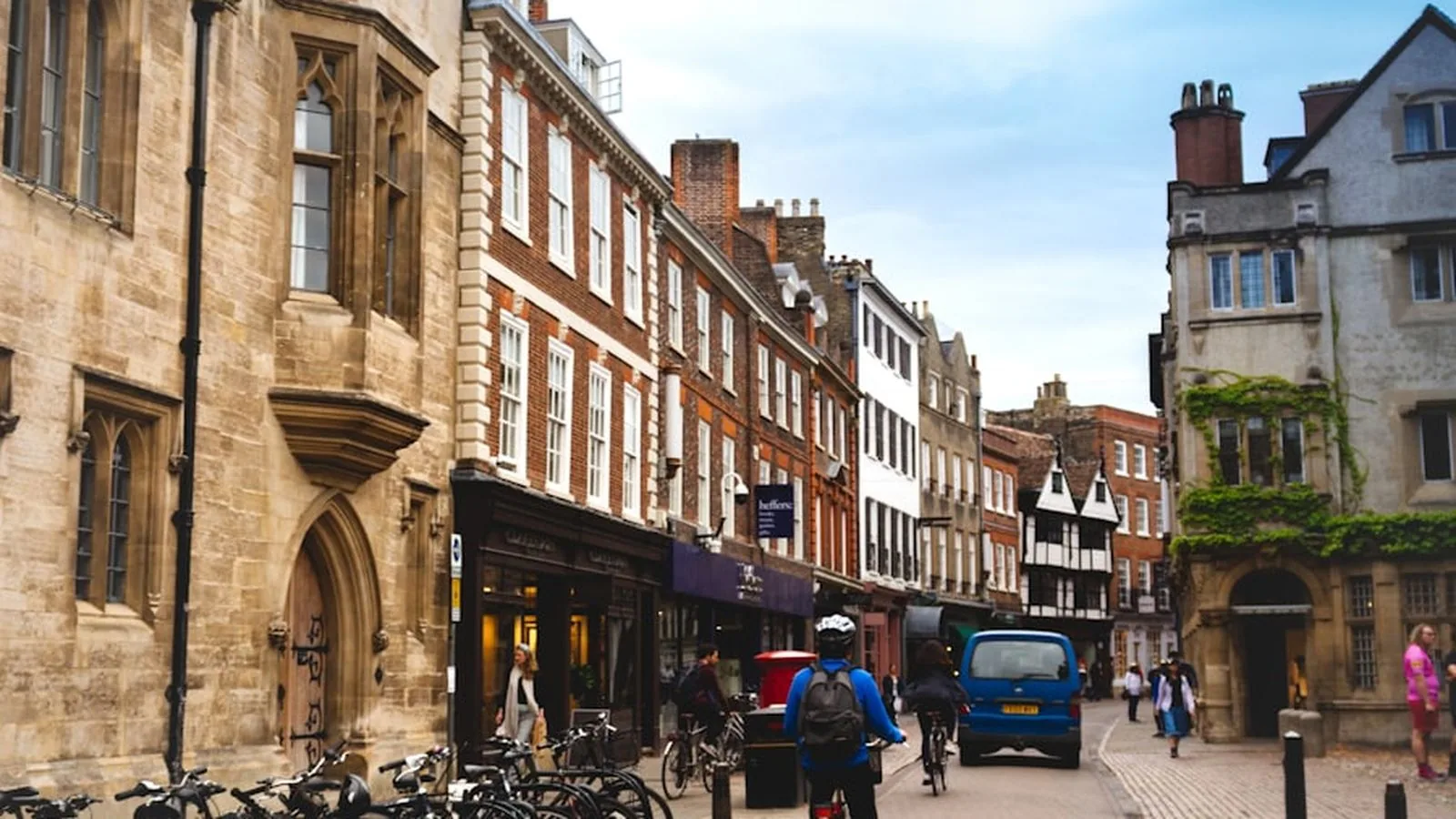 A Cambridge street with shops, bicycles and people