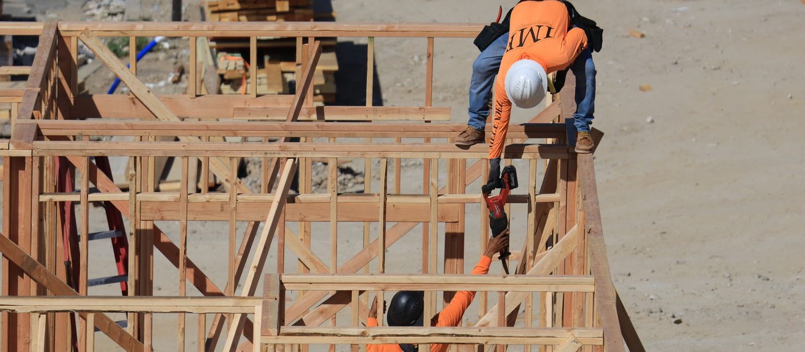 A builder working on a timber frame