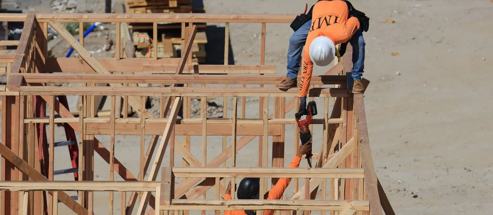 A builder working on a timber frame