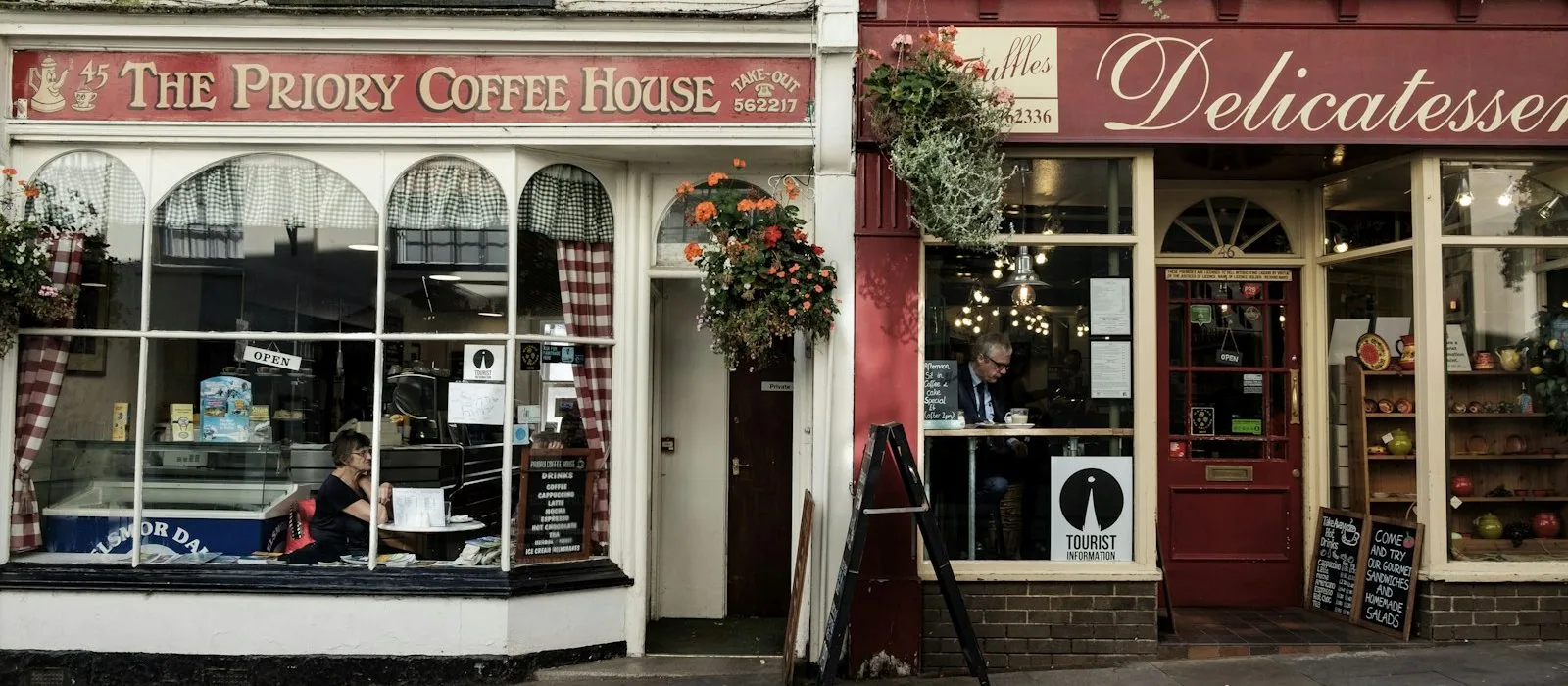 A coffee house and a delicatessen side by side on a high street