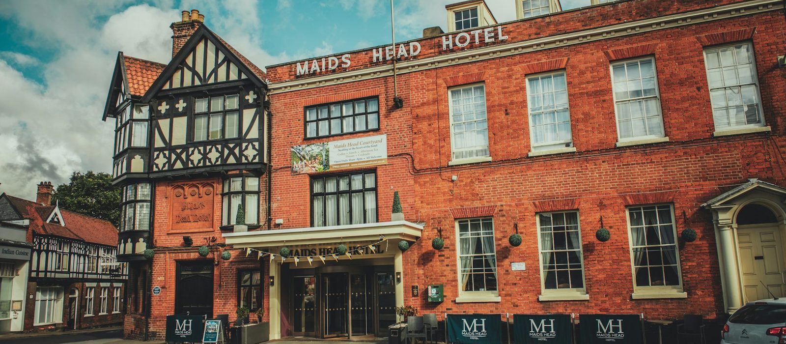 A timber framed hotel and brick frontage on a Norwich street
