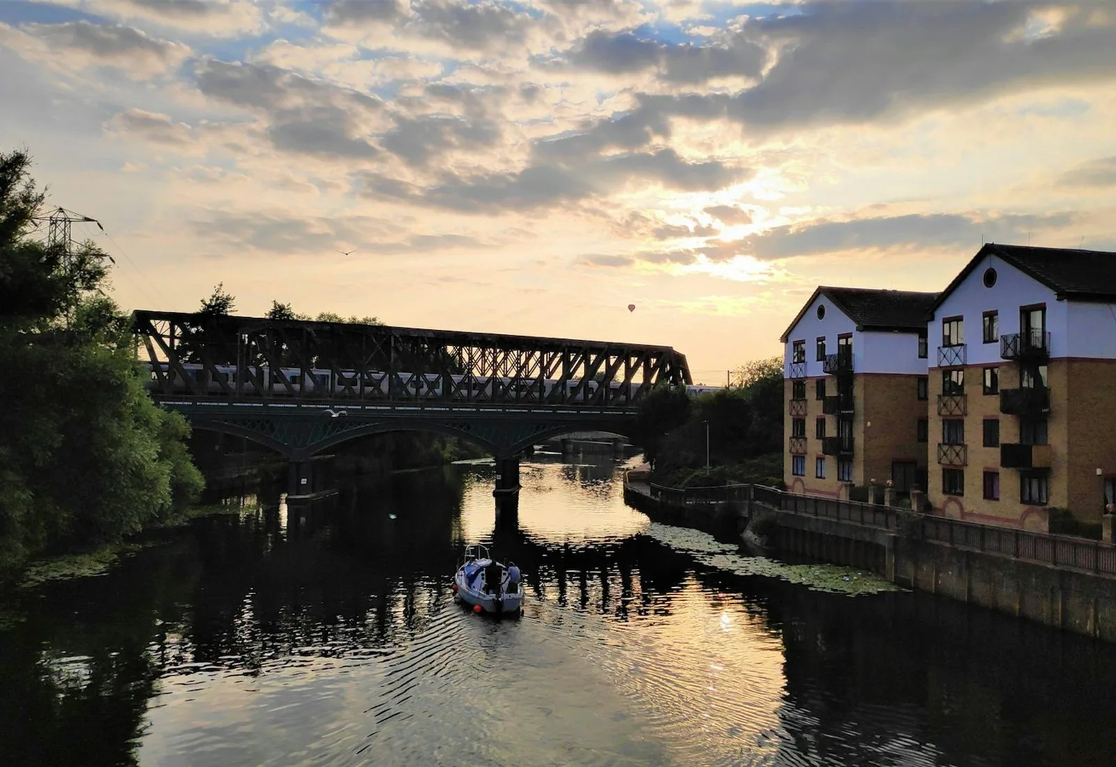The river at Peterborough at sunset, with a bridge and buildings along the bank