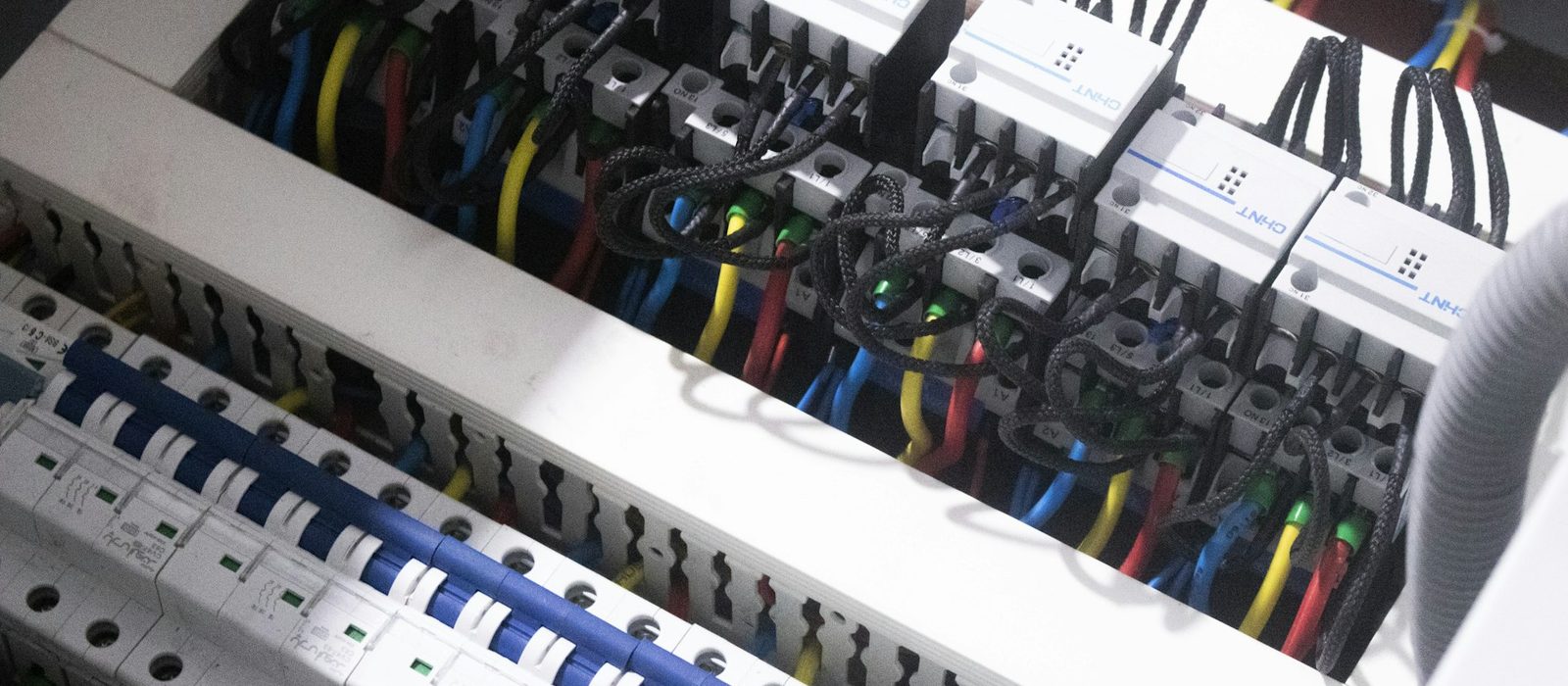 The inside of a consumer unit, breakers and wiring