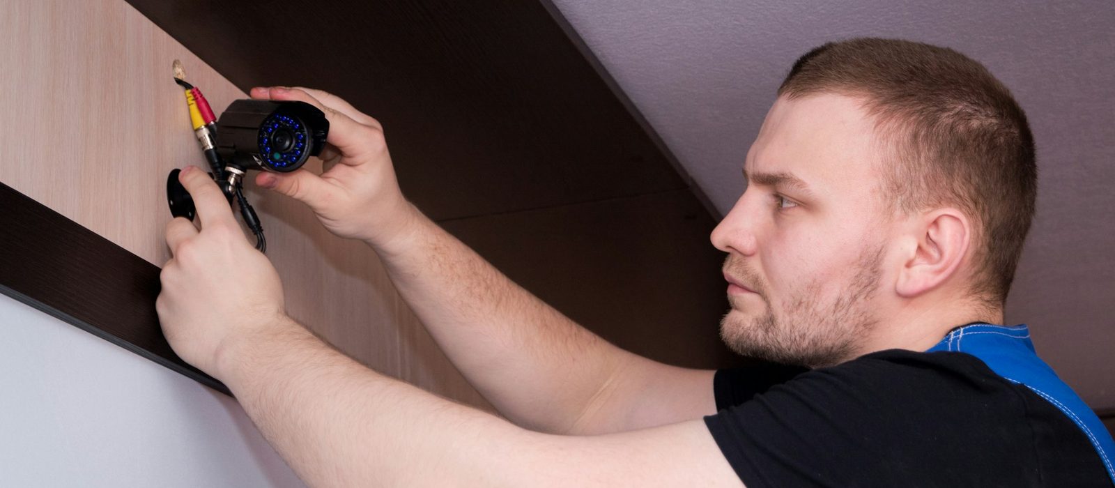 An electrician fitting a socket to a wall
