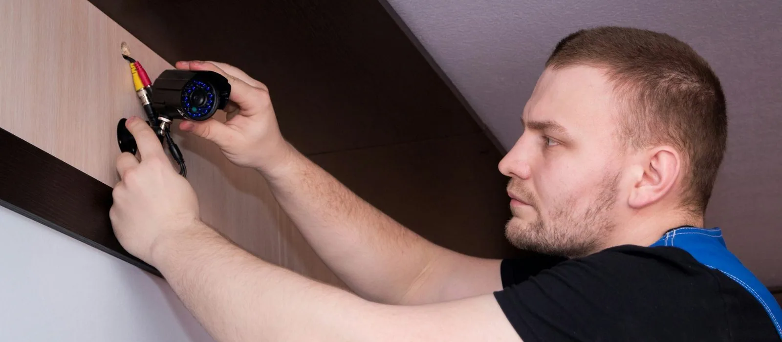 An electrician fitting a socket to a wall