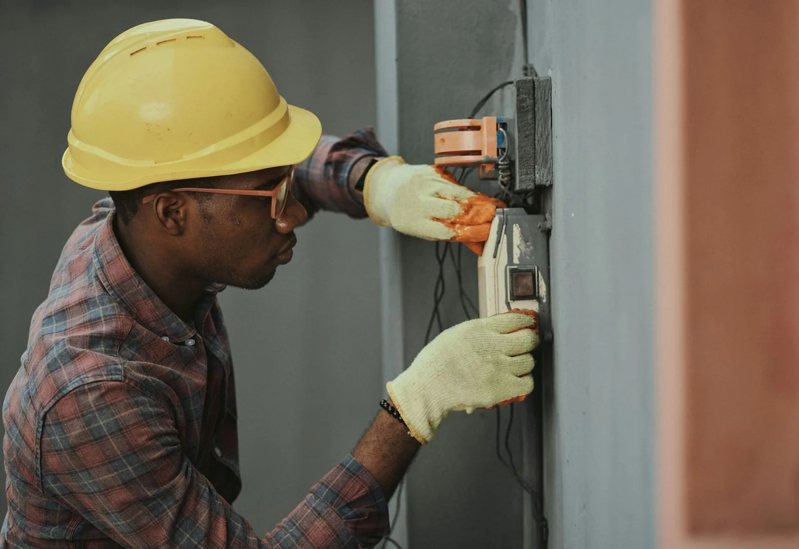 An electrician wiring a consumer unit