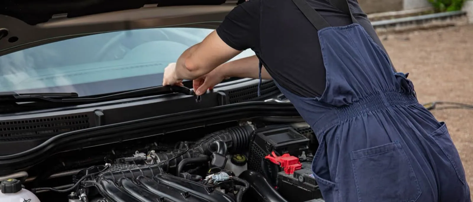 A mechanic working under a bonnet, from the SV Autos site